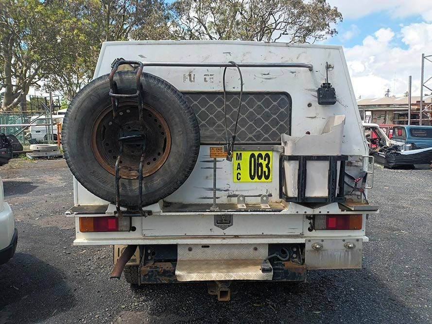 A White Truck with a Yellow License Plate That Says 063 — South West 4WD Wreckers in Harristown, QLD 
