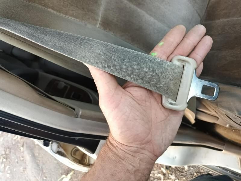 A Person is Holding a Seat Belt in Their Hand — South West 4WD Wreckers In Harristown, QLD