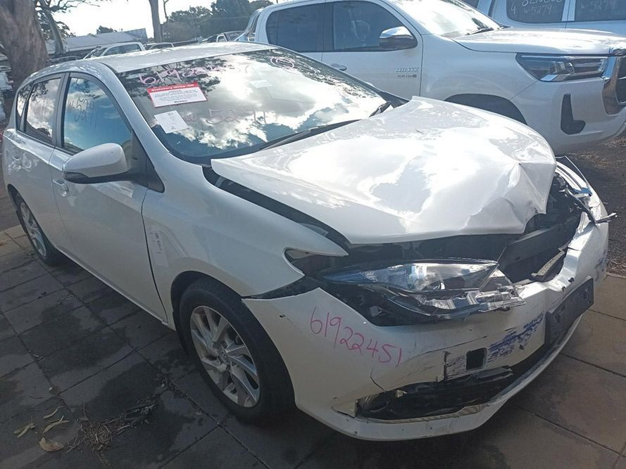 A White Car with a Damaged Front End is Parked on the Side of the Road — South West 4WD Wreckers in Harristown, QLD