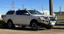A White Truck is Parked in a Parking Lot Next to a Pole — South West 4WD Wreckers In Brisbane, QLD