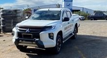 A White Truck is Parked in a Parking Lot in Front of a Building — South West 4WD Wreckers In Brisbane, QLD