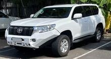 A White Toyota Land Cruiser is Parked in a Parking Lot — South West 4WD Wreckers In Brisbane, QLD