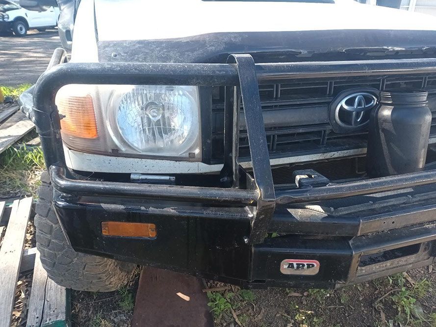 A White Toyota Truck with a Black Bumper is Parked in a Parking Lot — South West 4WD Wreckers in Harristown, QLD