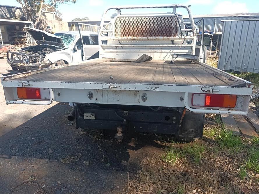 A Flatbed Truck is Parked on the Side of the Road — South West 4WD Wreckers in Harristown, QLD