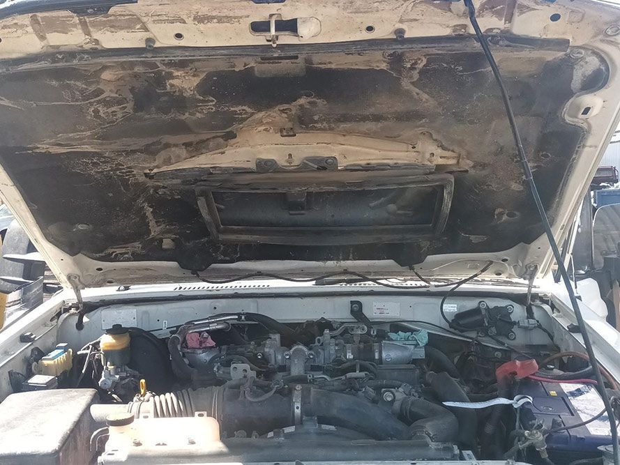 The Hood of a Car is Open and Shows the Engine — South West 4WD Wreckers in Harristown, QLD