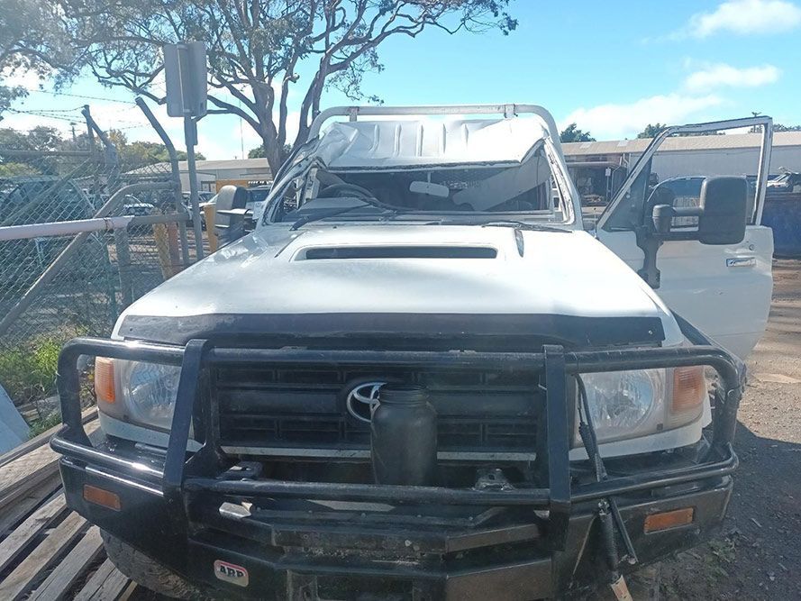 A White Truck with a Black Bumper is Parked in a Parking Lot — South West 4WD Wreckers in Harristown, QLD