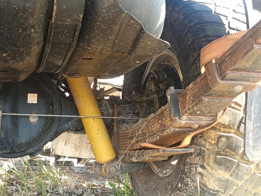 A Yellow Shock Absorber is Attached to the Back of a Truck — South West 4WD Wreckers in Harristown, QLD