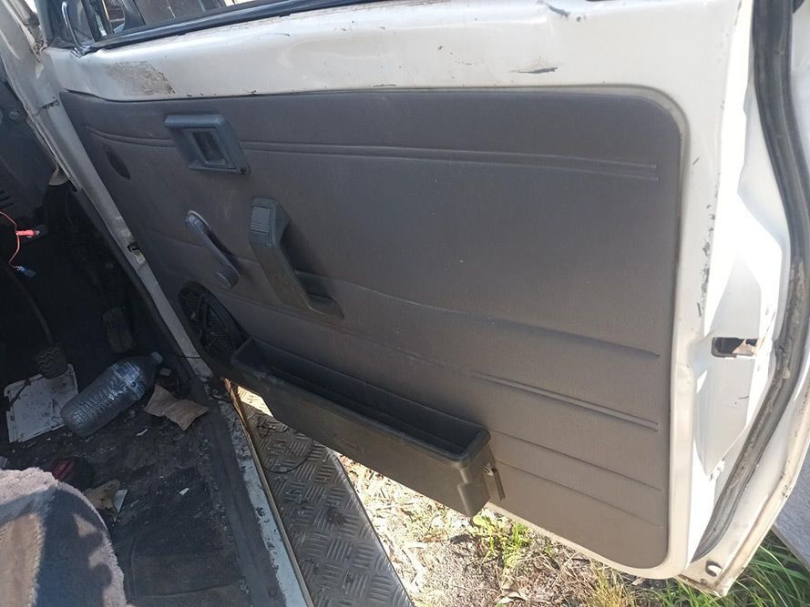 A White Car with the Door Open is Parked on the Side of the Road — South West 4WD Wreckers in Harristown, QLD