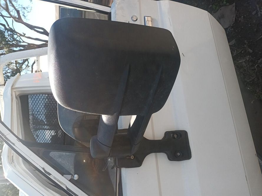 A Black Side Mirror is Attached to the Side of a White Truck — South West 4WD Wreckers in Harristown, QLD