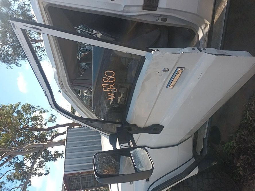 A White Truck with the Door Open and a Mirror on the Side — South West 4WD Wreckers in Harristown, QLD