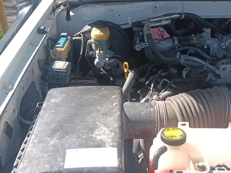 A Close Up of the Engine of a White Car — South West 4WD Wreckers in Harristown, QLD