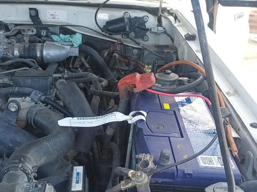 A Close Up of a Car Engine with a Purple Battery — South West 4WD Wreckers in Harristown, QLD