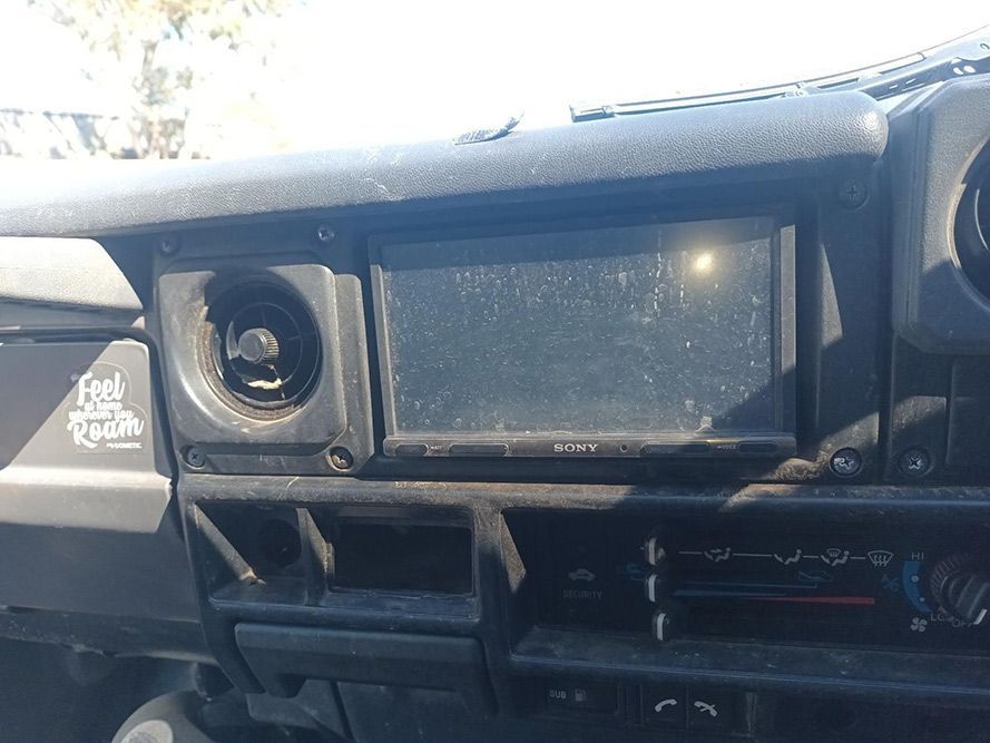 The Dashboard of a Car with a Radio and a Sticker That Says Feel the Roam — South West 4WD Wreckers in Harristown, QLD