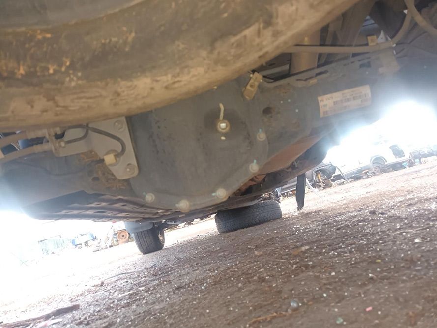 The Underside of a Car is Shown in a Parking Lot — South West 4WD Wreckers in Harristown, QLD