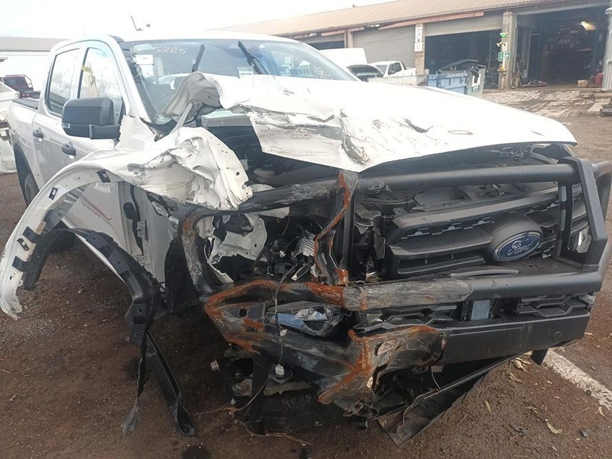 A White Truck with a Damaged Front End is Parked in a Parking Lot — South West 4WD Wreckers in Harristown, QLD