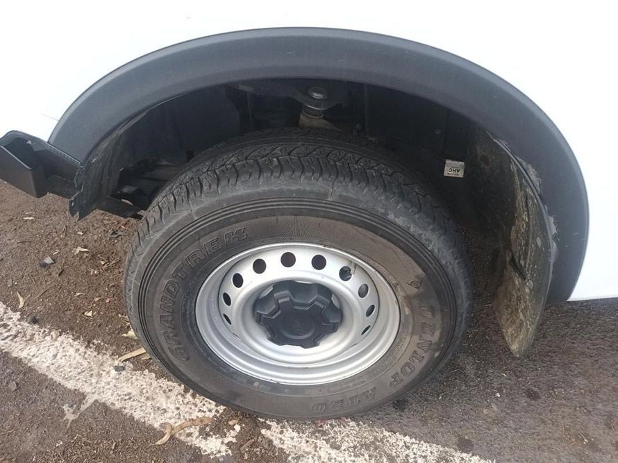A Close Up of a Tire on a White Van in a Parking Lot — South West 4WD Wreckers in Harristown, QLD