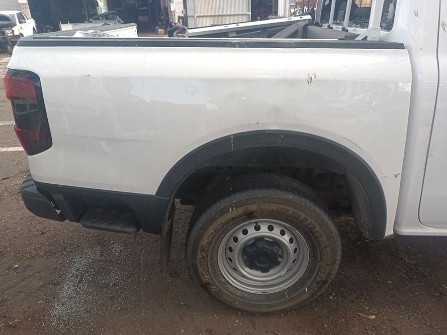 A White Truck is Parked on the Side of the Road — South West 4WD Wreckers in Harristown, QLD