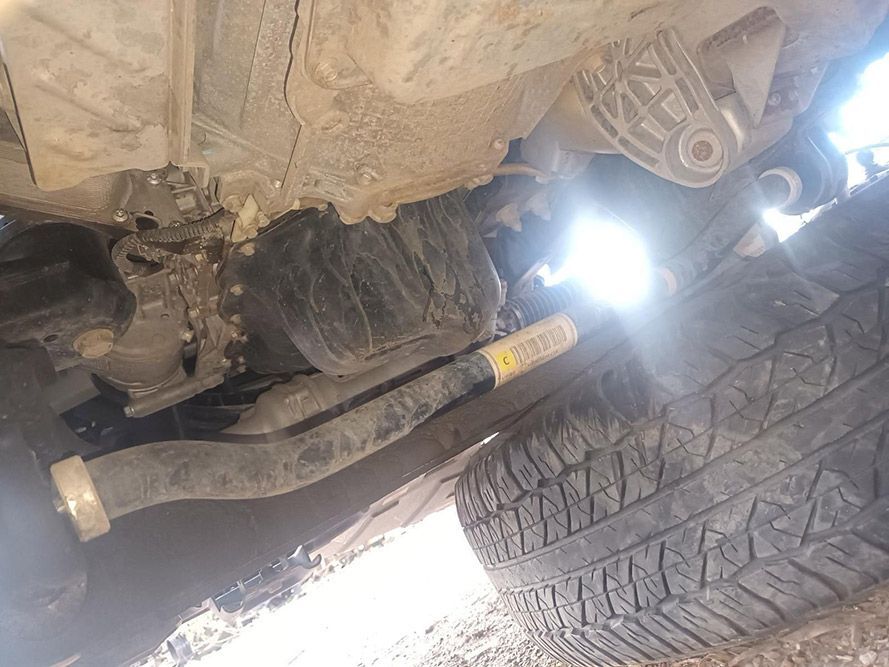 A Close Up of the Underside of a Car with a Tire in the Foreground — South West 4WD Wreckers in Harristown, QLD