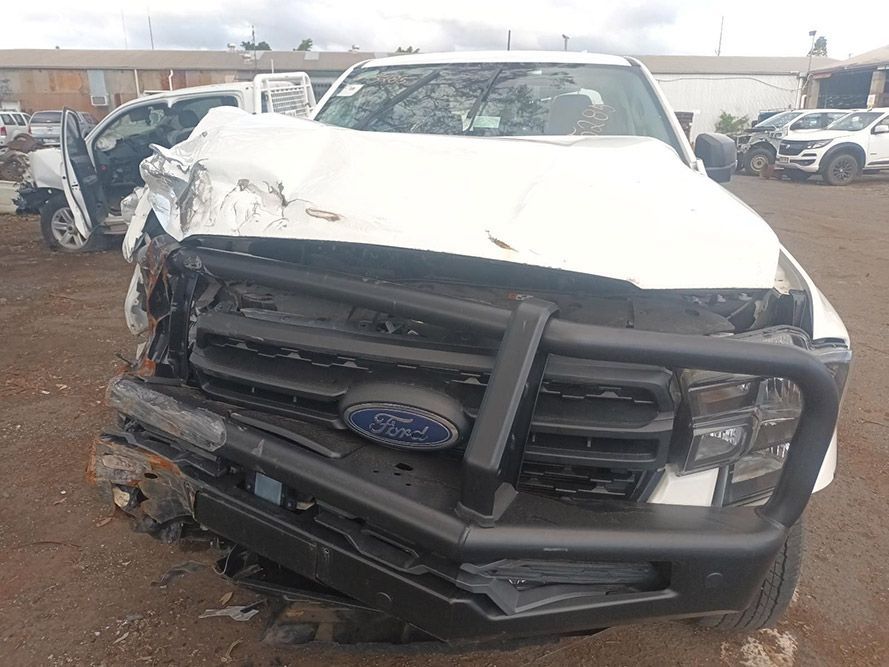 A White Ford Truck with a Black Bumper is Sitting in a Parking Lot — South West 4WD Wreckers in Harristown, QLD