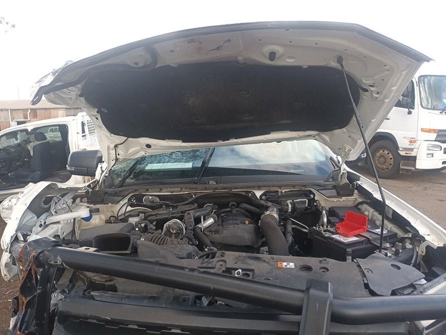 The Hood of a White Truck is Open and the Engine is Visible — South West 4WD Wreckers in Harristown, QLD
