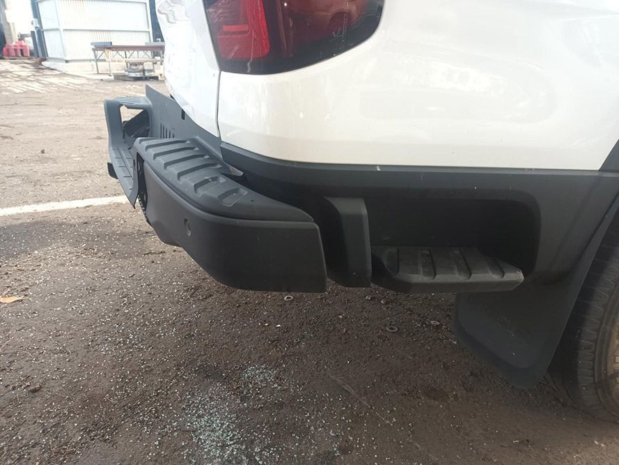 A White Truck with a Black Bumper is Parked in a Parking Lot — South West 4WD Wreckers in Harristown, QLD
