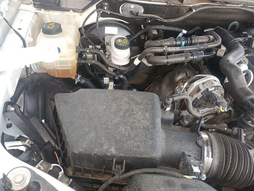 A Close Up of the Engine of a White Car — South West 4WD Wreckers in Harristown, QLD