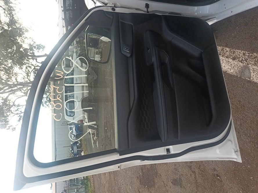 A White Car with the Door Open is Parked on the Side of the Road — South West 4WD Wreckers in Harristown, QLD