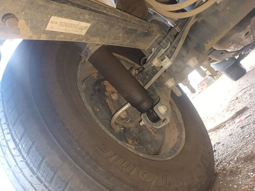 A Close Up of a Tire on a Car with a Shock Absorber Attached to It — South West 4WD Wreckers in Harristown, QLD