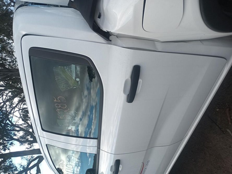 A White Truck with a Damaged Door is Parked on the Side of the Road — South West 4WD Wreckers in Harristown, QLD