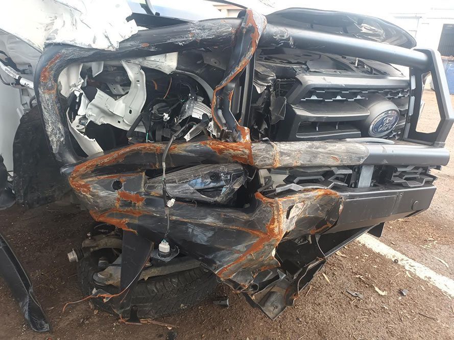 A Damaged Car is Sitting on the Ground in a Parking Lot — South West 4WD Wreckers in Harristown, QLD