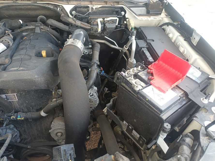 A Close Up of a Car Engine with a Red Battery Cover — South West 4WD Wreckers in Harristown, QLD