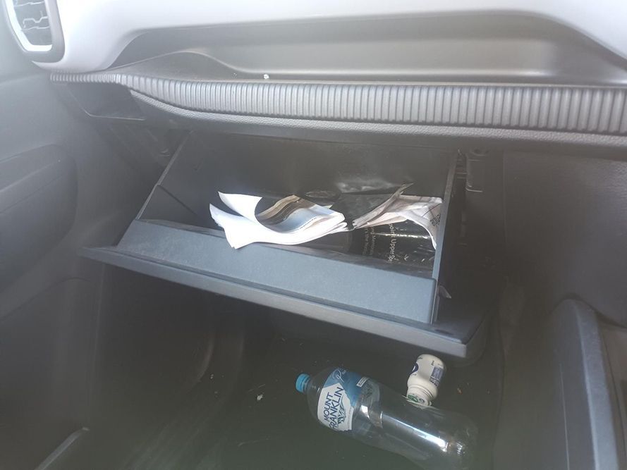 A Car Glovebox with a Bottle of Water and a Napkin in It — South West 4WD Wreckers in Harristown, QLD