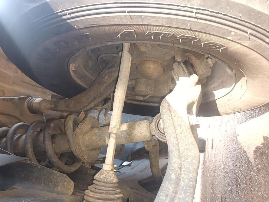 A Close Up of the Underside of a Car with a Tire on It — South West 4WD Wreckers in Harristown, QLD