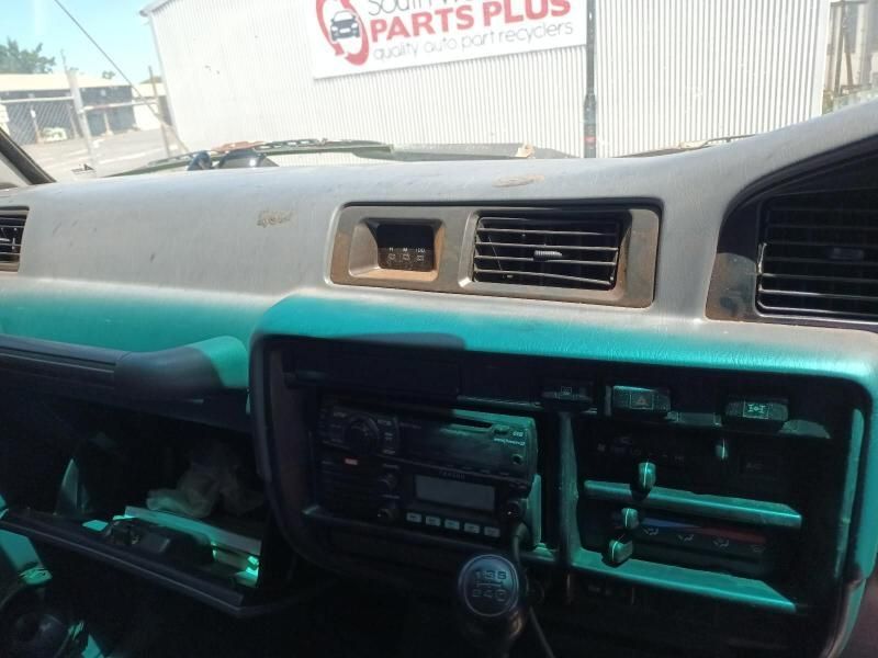 A Car Dashboard With a Sign in the Background That Says Parts Plus — South West 4WD Wreckers In Brisbane, QLD