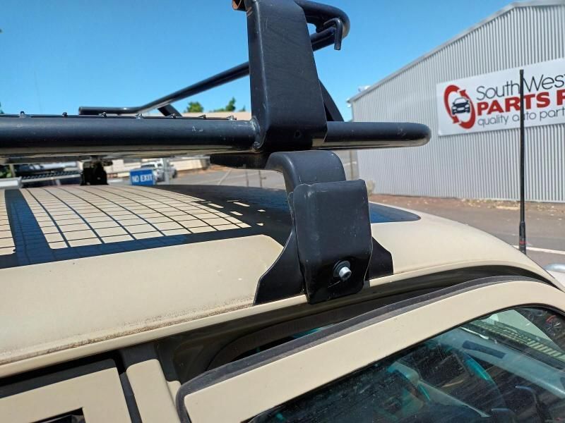 A Car With a Roof Rack is Parked in Front of a Southwest Parts Store — South West 4WD Wreckers In Brisbane, QLD