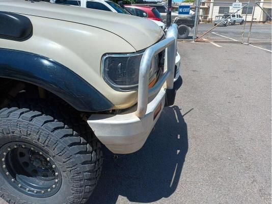A Tan Truck With Black Fender Flares is Parked in a Parking Lot — South West 4WD Wreckers In Brisbane, QLD