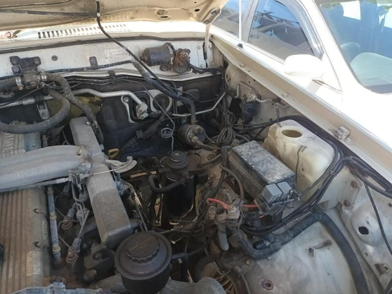 The Engine of a White Car With the Hood Open — South West 4WD Wreckers In Brisbane, QLD
