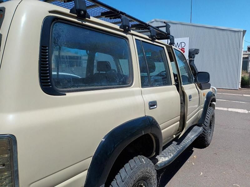 A Tan Suv With a Roof Rack is Parked in a Parking Lot— South West 4WD Wreckers In Brisbane, QLD