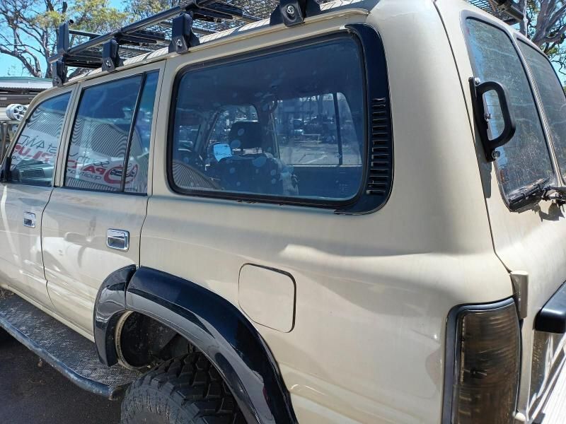A White Suv With a Roof Rack is Parked in a Parking Lot — South West 4WD Wreckers In Brisbane, QLD