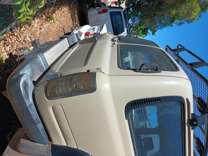 A White Truck is Parked on the Side of the Road — South West 4WD Wreckers In Brisbane, QLD