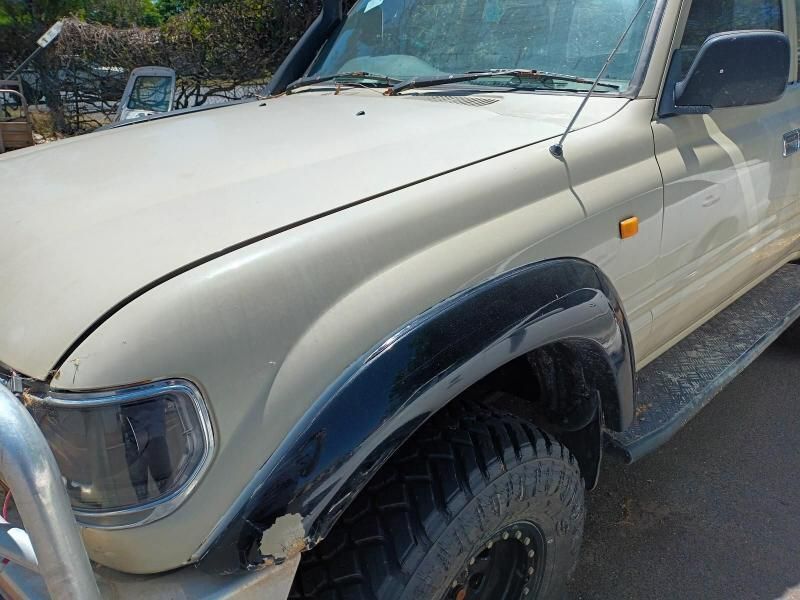 A White Truck With Black Fender Flares is Parked on the Side of the Road — South West 4WD Wreckers In Brisbane, QLD