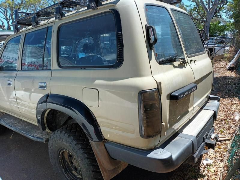 A Tan Suv With a Roof Rack is Parked on the Side of the Road — South West 4WD Wreckers In Brisbane, QLD