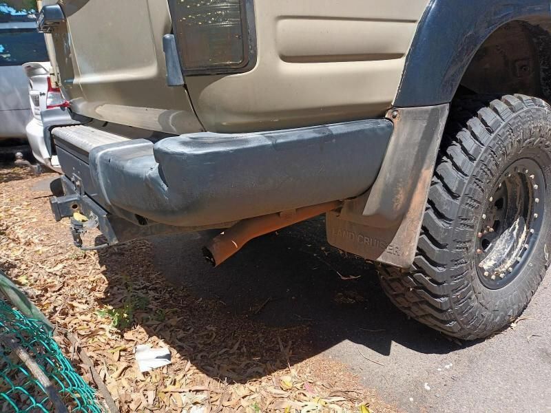 The Rear End of a Truck is Parked on the Side of the Road — South West 4WD Wreckers In Brisbane, QLD