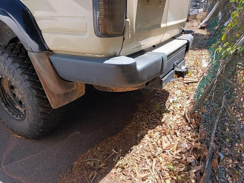 A White Truck With a Black Bumper is Parked Next to a Fence — South West 4WD Wreckers In Brisbane, QLD