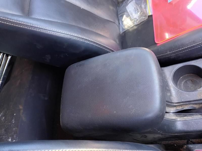 A Black Leather Arm Rest in a Car With a Cup Holder — South West 4WD Wreckers In Brisbane, QLD