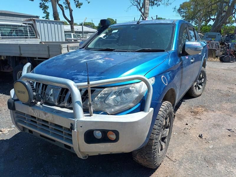 A Blue Truck is Parked in a Dirt Lot — South West 4WD Wreckers In Brisbane, QLD