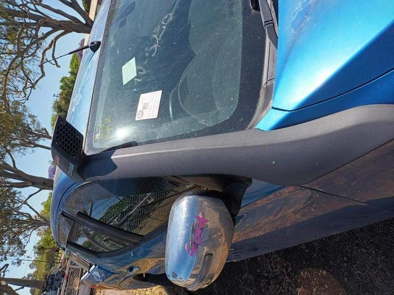 A Blue Car is Parked on the Side of the Road With Trees in the Background — South West 4WD Wreckers In Brisbane, QLD