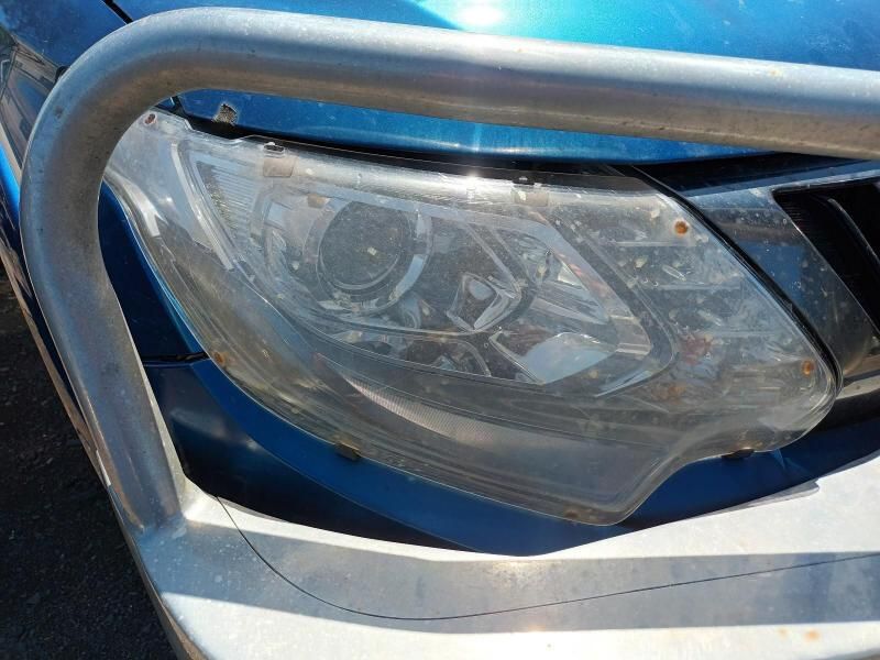 A Close Up of a Blue Cars Headlight With a Chrome Bumper — South West 4WD Wreckers In Brisbane, QLD