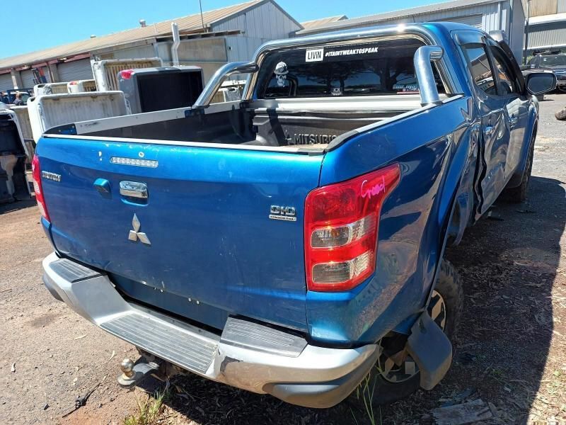 A Blue Mitsubishi Triton Pickup Truck is Parked in a Parking Lot — South West 4WD Wreckers In Brisbane, QLD