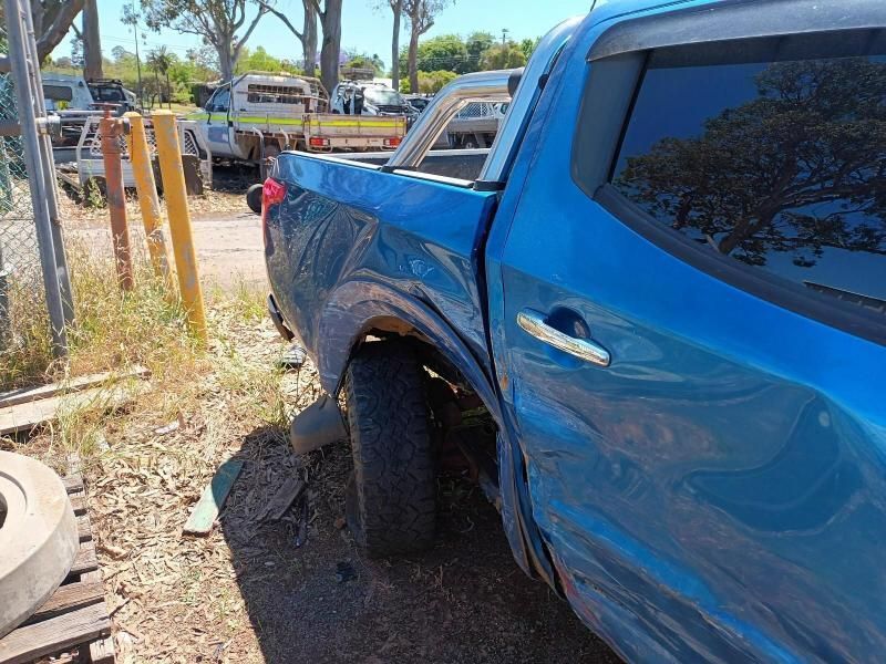 A Blue Truck is Parked in a Dirt Lot Next to a Fence — South West 4WD Wreckers In Brisbane, QLD